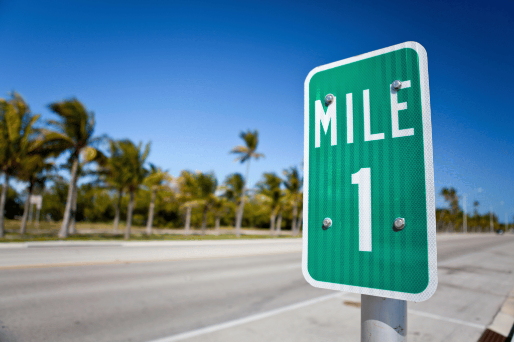 mile marker 1 sign on the road while running a mile
