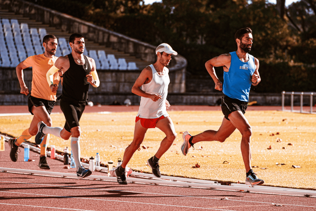 Men running on a local track