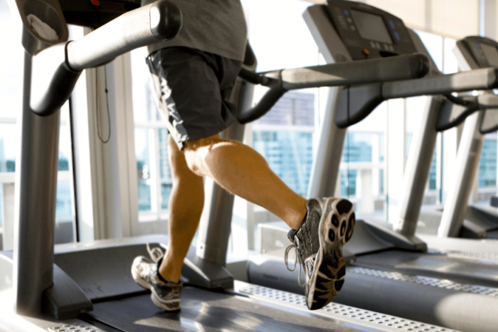 Man in longer running shorts on a treadmill.