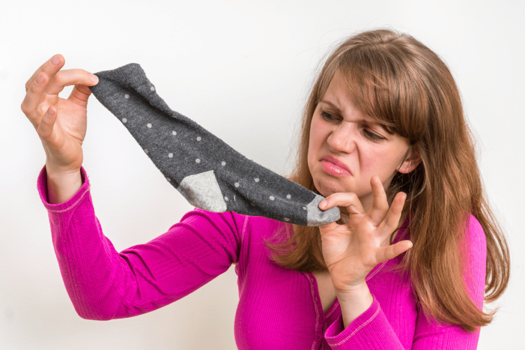 Running socks may smell bad even after washing because of trapped bacteria.
