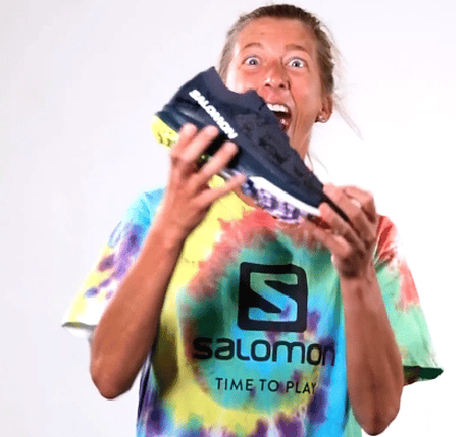 Courtney Dauwalter holding a Salomon shoes
